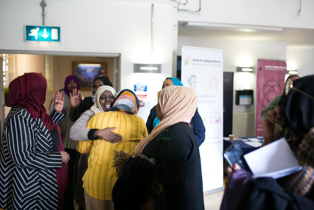 Two somali women hug and smile